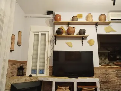 a living room with a flat screen tv and shelves at Bienvenidos Villa Roki Para información seis3tres 0nueve 0nueve veinte in El Puerto de Santa María
