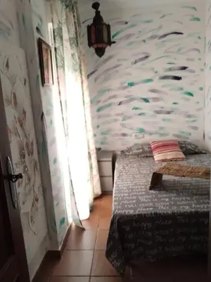 a bedroom with a bed with a fish wall at Bienvenidos Villa Roki Para información seis3tres 0nueve 0nueve veinte in El Puerto de Santa María