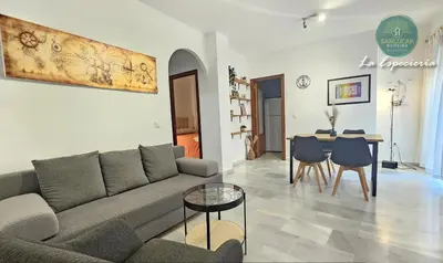 a living room with a couch and a table at La Especiería relax by Sanlúcar Housing in Sanlúcar de Barrameda
