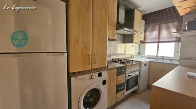 a kitchen with a refrigerator and a washing machine at La Especiería relax by Sanlúcar Housing in Sanlúcar de Barrameda