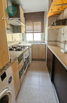 a kitchen with a sink and a stove top oven at La Especiería relax by Sanlúcar Housing in Sanlúcar de Barrameda