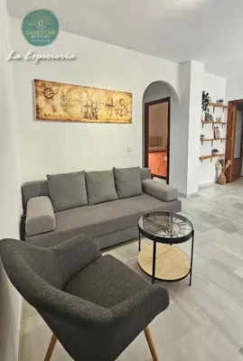 a living room with a couch and a table at La Especiería relax by Sanlúcar Housing in Sanlúcar de Barrameda