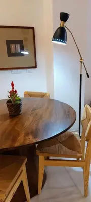 a wooden dining table with a lamp and a chair at el 2 de Flamenco BajoA in Cádiz
