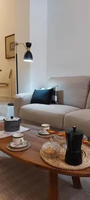 a living room with a couch and a coffee table at el 2 de Flamenco BajoA in Cádiz