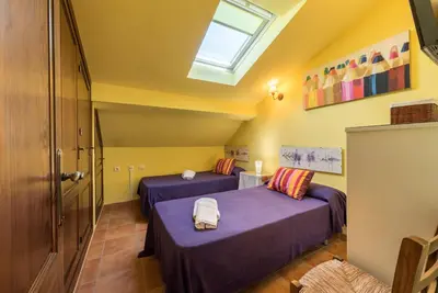 a room with two beds and a skylight at Chalet Silvia in Chiclana de la Frontera