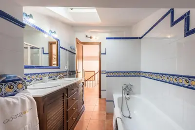 a bathroom with a tub and a sink and a bath tub at Chalet Silvia in Chiclana de la Frontera