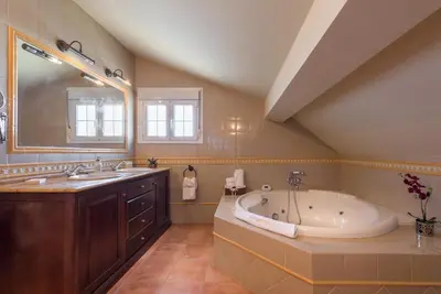 a large bathroom with a tub and a sink at Chalet Silvia in Chiclana de la Frontera