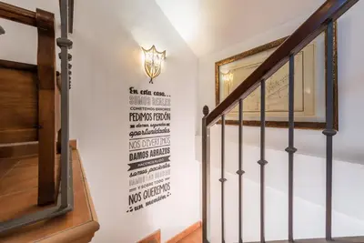 a staircase with a wall with a sign on it at Chalet Silvia in Chiclana de la Frontera