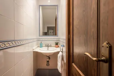 a bathroom with a sink and a mirror at Chalet Silvia in Chiclana de la Frontera