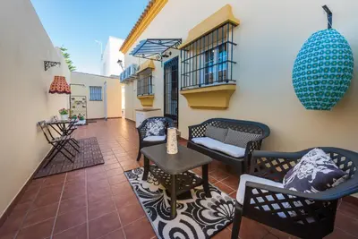 a balcony with chairs and a table on a building at Chalet Silvia in Chiclana de la Frontera