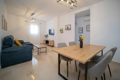 a living room with a table and a couch at Piso en el Barrio Alto in Sanlúcar de Barrameda