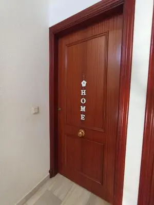 a wooden door with a sign on it at Leo's Home in Arcos de la Frontera