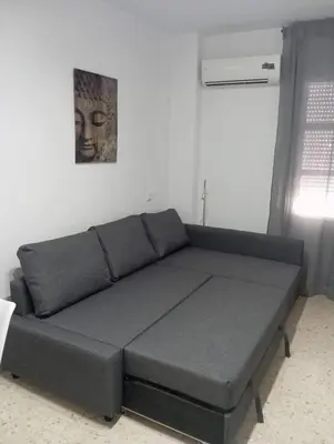 a couch in a room with a picture on the wall at Leo's Home in Arcos de la Frontera