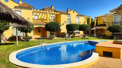 a swimming pool in front of a house at Pantoque Sani Ideal para familias in El Puerto de Santa María