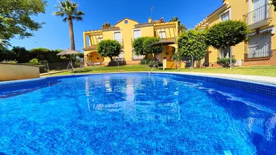 a swimming pool in front of a house at Pantoque Sani Ideal para familias in El Puerto de Santa María