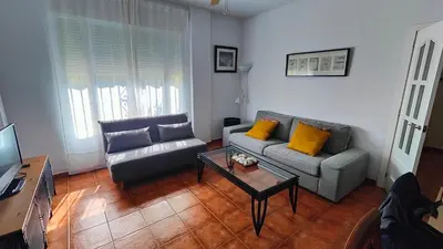 a living room with a couch and a coffee table at Pantoque Sani Ideal para familias in El Puerto de Santa María