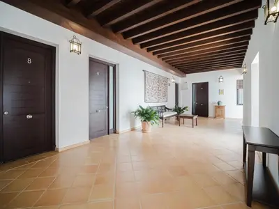 a hallway with white walls and a wooden ceiling at Sibs Sanlucar Fariñas 11 Edif Historico Renovado Ideal Parejas in Sanlúcar de Barrameda