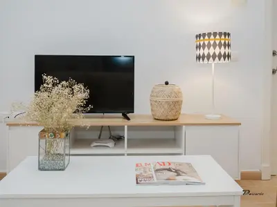 a living room with a television on a table at Sibs Sanlucar Fariñas 11 Edif Historico Renovado Ideal Parejas in Sanlúcar de Barrameda