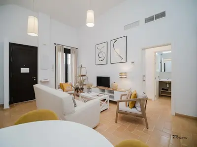 a living room with a couch and a table at Sibs Sanlucar Fariñas 11 Edif Historico Renovado Ideal Parejas in Sanlúcar de Barrameda
