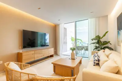 a living room with a couch and a tv at Costa Ballena Deluxe Seafront by Valcambre in Cádiz