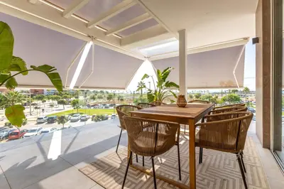 a dining room with a table and chairs on a balcony at Costa Ballena Deluxe Seafront by Valcambre in Cádiz