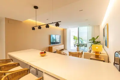 a living room with a large white table and chairs at Costa Ballena Deluxe Seafront by Valcambre in Cádiz
