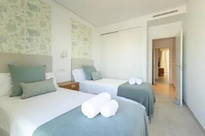 two beds in a room with blue and white at Costa Ballena Deluxe Seafront by Valcambre in Cádiz