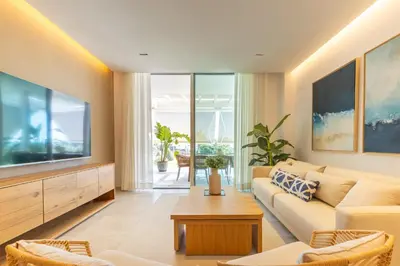 a living room with a couch and a large television at Costa Ballena Deluxe Seafront by Valcambre in Cádiz