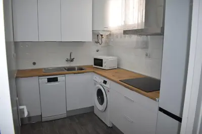 a white kitchen with a sink and a microwave at Piso IBERIAN PREMIUM in Sanlúcar de Barrameda