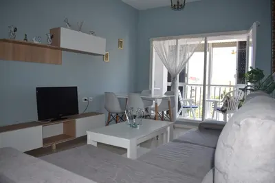 a living room with a couch and a tv at Piso IBERIAN PREMIUM in Sanlúcar de Barrameda