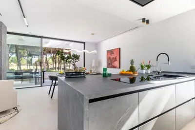 a kitchen with a large stainless steel counter top at Villa Gatán in Chiclana de la Frontera