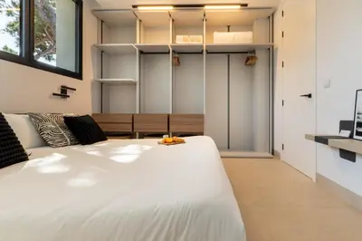 a bedroom with a large white bed in a room at Villa Gatán in Chiclana de la Frontera