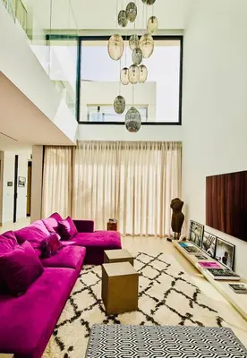 a large purple couch in a living room at Villa Gatán in Chiclana de la Frontera