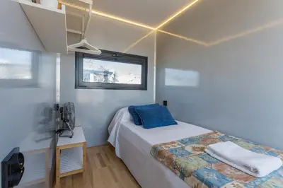a small bedroom with a bed and a window at Azvalia Luxury Casa Barco New York and Texas-Unique Houseboat Experience in El Puerto de Santa María