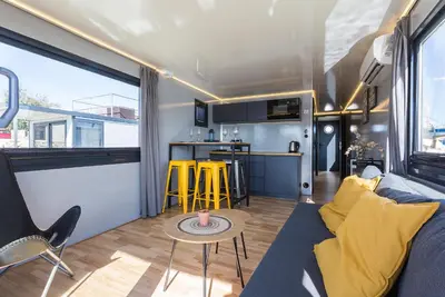 a living room with a couch and a table at Azvalia Luxury Casa Barco New York and Texas-Unique Houseboat Experience in El Puerto de Santa María