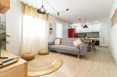 a living room with a couch and a table at AdEva Céntrico 3 Habitaciones in Jerez de la Frontera