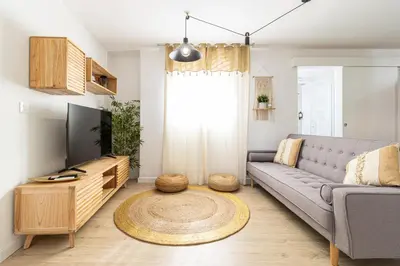 a living room with a couch and a tv at AdEva Céntrico 3 Habitaciones in Jerez de la Frontera