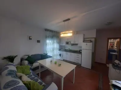 a living room with a couch and a table at apartamento Atlanta in Chipiona