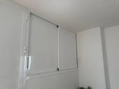 a white cabinet with glass doors in a room at apartamento Atlanta in Chipiona