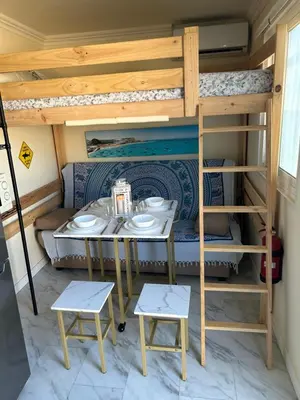 a room with a table and a bunk bed at Lugar acogedor al lado de La Barrosa in Campano
