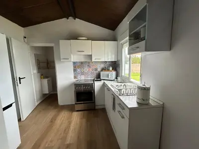 a kitchen with white cabinets and a stove top oven at Lugar acogedor al lado de La Barrosa in Campano