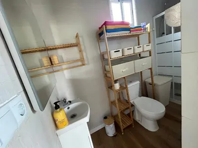 a small bathroom with a toilet and a sink at Lugar acogedor al lado de La Barrosa in Campano