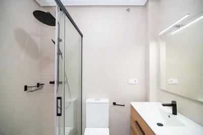a bathroom with a shower and a toilet and a sink at Pipoca's Beach in Novo Sancti Petri