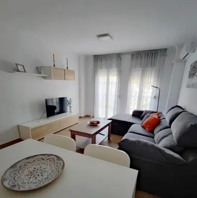 a living room with a couch and a table at Apto 5 personas con todo equipado in San Fernando