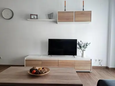 a living room with a television and a bowl of fruit at Apto 5 personas con todo equipado in San Fernando