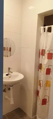 a white bathroom with a toilet and a sink at La Finquita in Chiclana de la Frontera