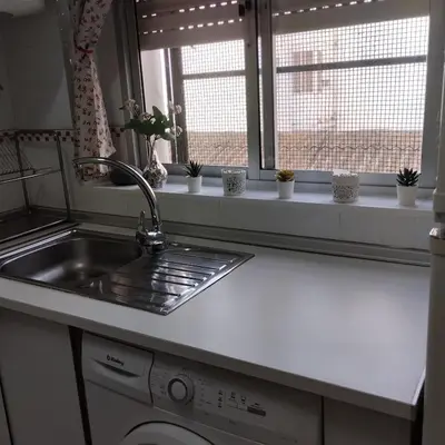 a kitchen counter with a sink and a window at Apartamento ESPERANZA DE LA YEDRA in Jerez de la Frontera