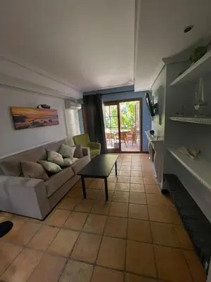 an empty room with a table and a glass door at Magnifico Bungalow 2 plantas 110 m,con 3 piscinas in San Fernando