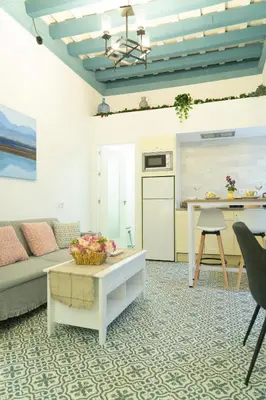 a living room with a couch and a table at T&S La Bóveda in Arcos de la Frontera