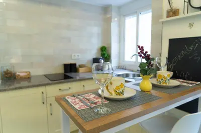 a kitchen with a table with two wine glasses on it at T&S La Bóveda in Arcos de la Frontera